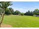 Large park area featuring swings, playground equipment, and a grassy field for outdoor recreation and enjoyment at 1170 Shellnut Trl, Hoschton, GA 30548