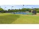 Community tennis courts are fenced and located on a well-maintained property with luscious lawn at 1170 Shellnut Trl, Hoschton, GA 30548