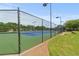 Well-maintained community tennis courts featuring lighting and fencing for recreational play at 1170 Shellnut Trl, Hoschton, GA 30548