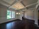 Elegant dining room featuring dark hardwood floors, coffered ceilings, and large windows at 7791 Capps Ridge Ln, Douglasville, GA 30135