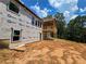 Back of home under construction featuring a second story wooden deck at 7791 Capps Ridge Ln, Douglasville, GA 30135