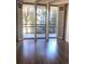 Bright room with access to a balcony through shuttered glass doors and dark hardwood flooring at 1130 Piedmont Ne Ave # 404, Atlanta, GA 30309