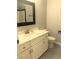 Well-lit bathroom featuring a sink with black framed mirror and a decorative tiled floor at 1130 Piedmont Ne Ave # 404, Atlanta, GA 30309