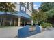 Upscale condo building entrance with manicured landscaping and prominent signage at 1130 Piedmont Ne Ave # 404, Atlanta, GA 30309