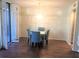 Dining area with stylish blue chairs, hardwood floors, and balcony access at 1130 Piedmont Ne Ave # 404, Atlanta, GA 30309