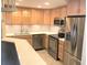 Well-lit kitchen featuring stainless steel appliances, light wood cabinets, and mosaic backsplash at 1130 Piedmont Ne Ave # 404, Atlanta, GA 30309