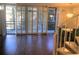 Open living area with wood floors, balcony access, and spiral staircase at 1130 Piedmont Ne Ave # 404, Atlanta, GA 30309
