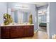 Bathroom with a double vanity, large mirror, tile floor, and view into the bedroom at 3832 Augustine Pl, Rex, GA 30273