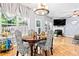 Elegant dining area with stylish chairs, contemporary lighting, and natural light at 3832 Augustine Pl, Rex, GA 30273