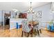 Charming dining area with a modern chandelier, view of the kitchen, and comfortable seating at 3832 Augustine Pl, Rex, GA 30273