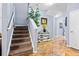Inviting foyer with staircase, elegant tile flooring, stylish console table, and decorative accents at 3832 Augustine Pl, Rex, GA 30273