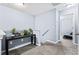 Carpeted hallway with a console table and plant decorations leading to a bedroom at 3832 Augustine Pl, Rex, GA 30273