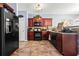 Well-appointed kitchen with cherry cabinets, modern appliances, and stylish countertops at 3832 Augustine Pl, Rex, GA 30273