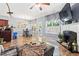 Open-concept living room with fireplace, tile floors, and view of dining area at 3832 Augustine Pl, Rex, GA 30273