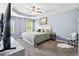 Spacious main bedroom with carpet, tray ceiling, and bright windows at 3832 Augustine Pl, Rex, GA 30273