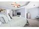 This spacious bedroom has carpet, large windows, a ceiling fan, and gray walls at 3832 Augustine Pl, Rex, GA 30273