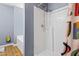 Shower with white shower head and tub surrounded with blue walls and a colorful shower curtain at 3832 Augustine Pl, Rex, GA 30273