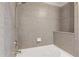 Tiled bathtub with shower head and built in shelving for storage at 400 W Peachtree St # 2108, Atlanta, GA 30308