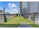 Well-maintained dog park featuring artificial turf, benches, a trash receptacle, and paw print decorations at 400 W Peachtree St # 2108, Atlanta, GA 30308