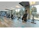 Bright gym offering treadmills, ellipticals, and stationary bikes with large windows overlooking city views at 400 W Peachtree St # 2108, Atlanta, GA 30308