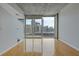 Living room with concrete ceilings, hardwood floors, and city views through a balcony at 400 W Peachtree St # 2108, Atlanta, GA 30308