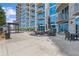 Common patio area featuring stylish tables and chairs, black umbrellas, and comfortable seating arrangements at 400 W Peachtree St # 2108, Atlanta, GA 30308