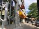 Sidewalk view with a Mellow Mushroom pizza restaurant visible and street parking at 400 W Peachtree St # 2108, Atlanta, GA 30308