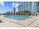 Stunning rooftop swimming pool with lounge chairs, umbrellas, and city views, offering a luxurious and relaxing experience at 400 W Peachtree St # 2108, Atlanta, GA 30308
