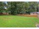 Large backyard featuring a well-maintained lawn and wooden privacy fence, ideal for Gathering gatherings at 1266 Elizabeth Sw Ave, Atlanta, GA 30310