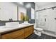 Modern bathroom with dual sinks, a marble-tiled shower, and stylish fixtures at 1266 Elizabeth Sw Ave, Atlanta, GA 30310