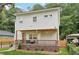 View of a two-story home featuring a welcoming front porch, landscaped yard, and a secure black fence at 1266 Elizabeth Sw Ave, Atlanta, GA 30310