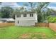 Home's exterior showcasing the fenced backyard, offering privacy and space for outdoor activities at 1266 Elizabeth Sw Ave, Atlanta, GA 30310