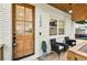 Inviting front porch with seating, showcasing a stylish wood door and a glimpse of the bright kitchen at 1266 Elizabeth Sw Ave, Atlanta, GA 30310