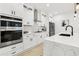 Modern kitchen with stainless steel appliances, sleek white cabinetry, and quartz countertops at 1266 Elizabeth Sw Ave, Atlanta, GA 30310