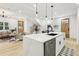 Bright, open-concept kitchen features quartz countertops, modern appliances, and a large island with bar seating at 1266 Elizabeth Sw Ave, Atlanta, GA 30310