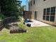 Backyard featuring a patio area, wood feature, garden beds and green grass at 455 Crafton Ct, Lawrenceville, GA 30043
