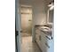 Renovated bathroom with marble floors, white cabinets, granite countertop and tiled walk-in shower at 455 Crafton Ct, Lawrenceville, GA 30043