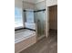 Bathroom featuring a tiled shower, garden tub, and tiled floors at 455 Crafton Ct, Lawrenceville, GA 30043