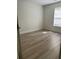 Cozy bedroom featuring wood-look floors, neutral walls, and a bright window at 455 Crafton Ct, Lawrenceville, GA 30043