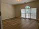 Bedroom featuring neutral walls, wood-look flooring, and a bright window offering ample natural light at 455 Crafton Ct, Lawrenceville, GA 30043