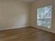 Bright bedroom features neutral walls, wood-look flooring, and a large window offering ample natural light at 455 Crafton Ct, Lawrenceville, GA 30043