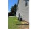 Side exterior view showcasing air conditioning units and well-maintained lawn at 455 Crafton Ct, Lawrenceville, GA 30043