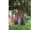 Exterior view of a brick two-story home with mature trees and front lawn at 455 Crafton Ct, Lawrenceville, GA 30043