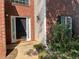 Charming brick home featuring a front door framed by sidelights and a blooming rose bush at 455 Crafton Ct, Lawrenceville, GA 30043