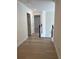 Well-lit hallway with wood laminate flooring and white trim detail leads to upper level at 455 Crafton Ct, Lawrenceville, GA 30043