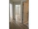 Hallway featuring wood-look floors and multiple doorways to other rooms at 455 Crafton Ct, Lawrenceville, GA 30043