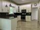Modern kitchen with white cabinets, dark countertops, stainless steel appliances and tile flooring at 455 Crafton Ct, Lawrenceville, GA 30043
