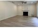 Spacious living room featuring hardwood floors, fireplace, and neutral color palette at 455 Crafton Ct, Lawrenceville, GA 30043