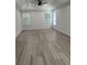 Spacious main bedroom with a trey ceiling, ceiling fan and wood-look floors at 455 Crafton Ct, Lawrenceville, GA 30043