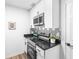 A close-up of a kitchen features stainless steel appliances, granite countertops, and stylish backsplash at 197 Holcomb Ferry Rd, Roswell, GA 30076